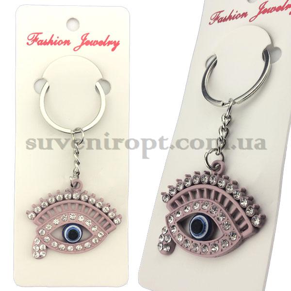 Брелок в упаковке глаз с ресницей  металлический в камушках  (12)