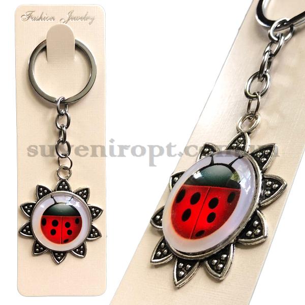 Брелок металлический  в упаковке стекло божья коровка в цветке  (12)
