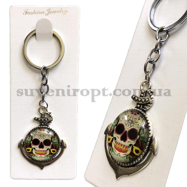 Брелок металл в упаковке якорь с черепом стекло  (12)