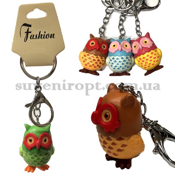 Брелок в упаковці сова кольорова полістоун (12)